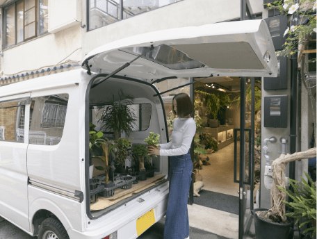 エブリイの荷室から観葉植物を取り出す様子