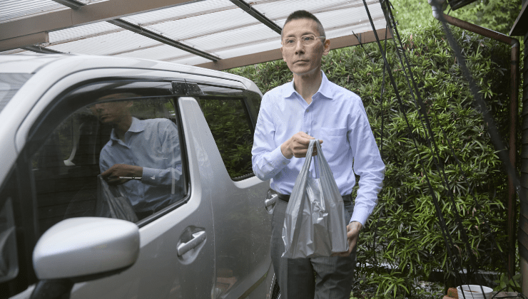 ワゴンRから降りて薬を配達する様子